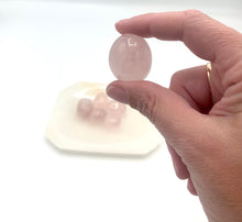 Load image into Gallery viewer, Holding a rose quartz tumble