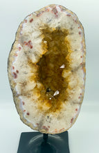 Load image into Gallery viewer, Large Citrine cave on black stand.