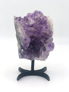 Amethyst cluster  on black metal stand 