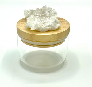 clear quartz on jar with wooden lid. 