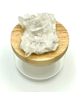Clear quartz on wooden lid with glass jar 