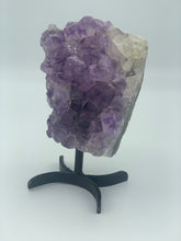 Load image into Gallery viewer, amethyst cluster  on black metal stand side 
