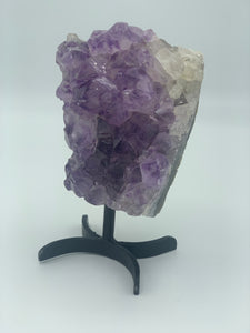 amethyst cluster  on black metal stand side 