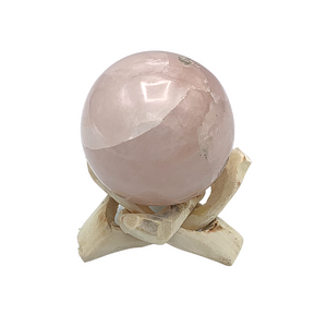 light brown wooden stand with rose quartz sphrere 