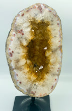 Load image into Gallery viewer, Large Citrine cave on black stand. 
