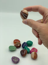 Load image into Gallery viewer, mixed banded agate tumbles with one being held
