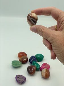 mixed banded agate tumbles with one being held