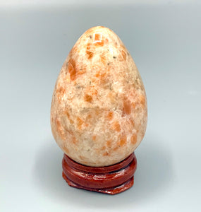 sunstone egg on wooden stand 